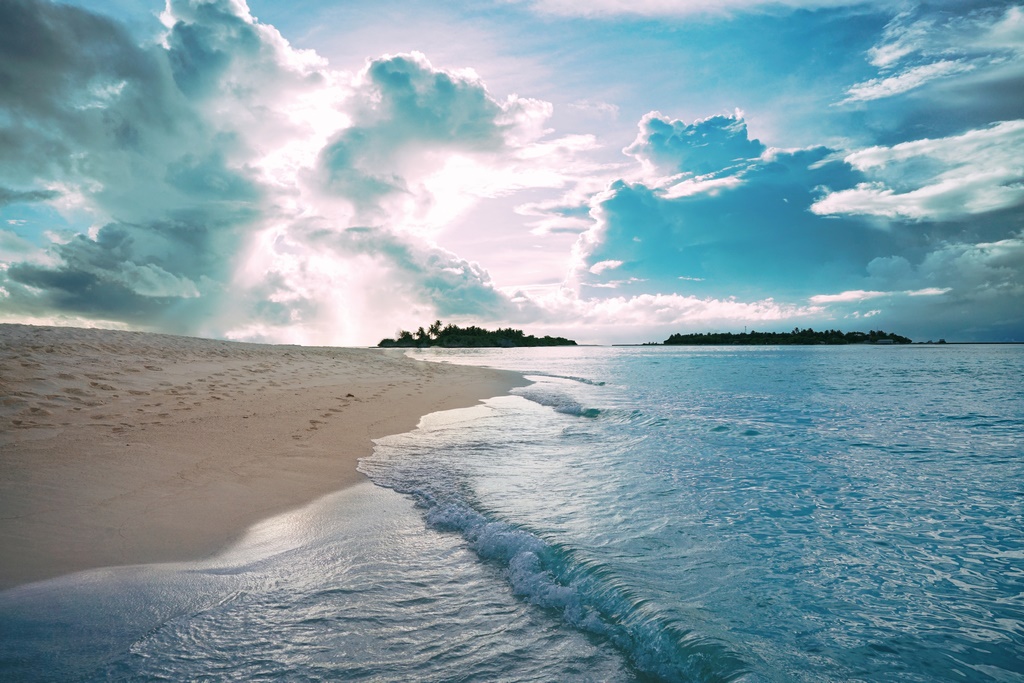 Beautiful tropical sunset with stormy textured sky and golden be