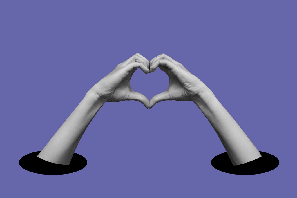 Human female hands showing a heart shape isolated on a very peri